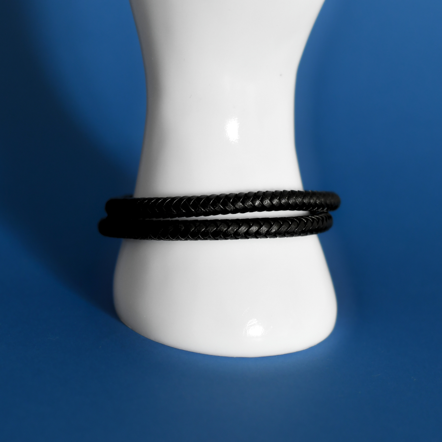 ACUIR genuine leather braided bracelet in black with stainless steel clasp for men on hand 