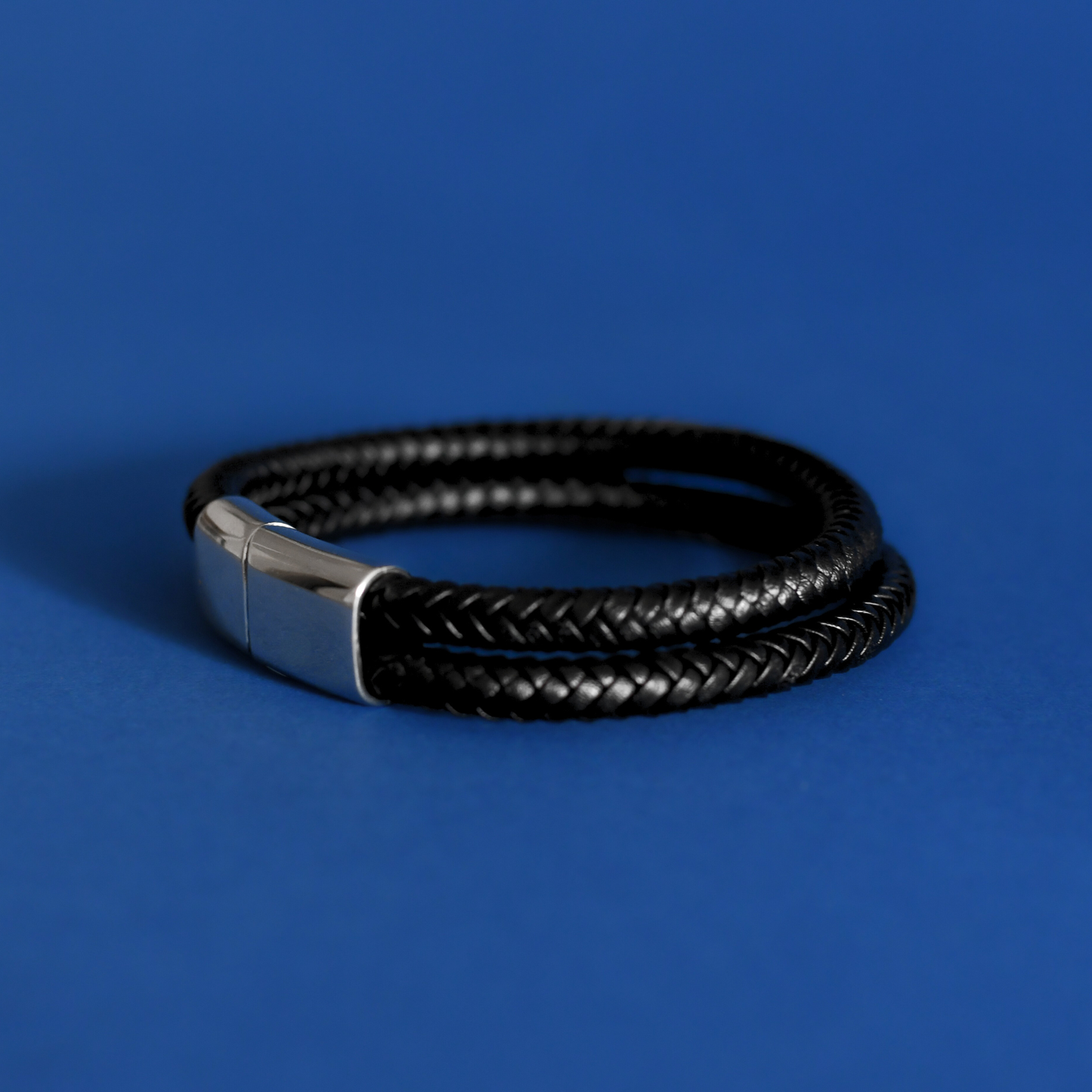 ACUIR genuine leather braided bracelet in black with stainless steel clasp for men close up - Alogan