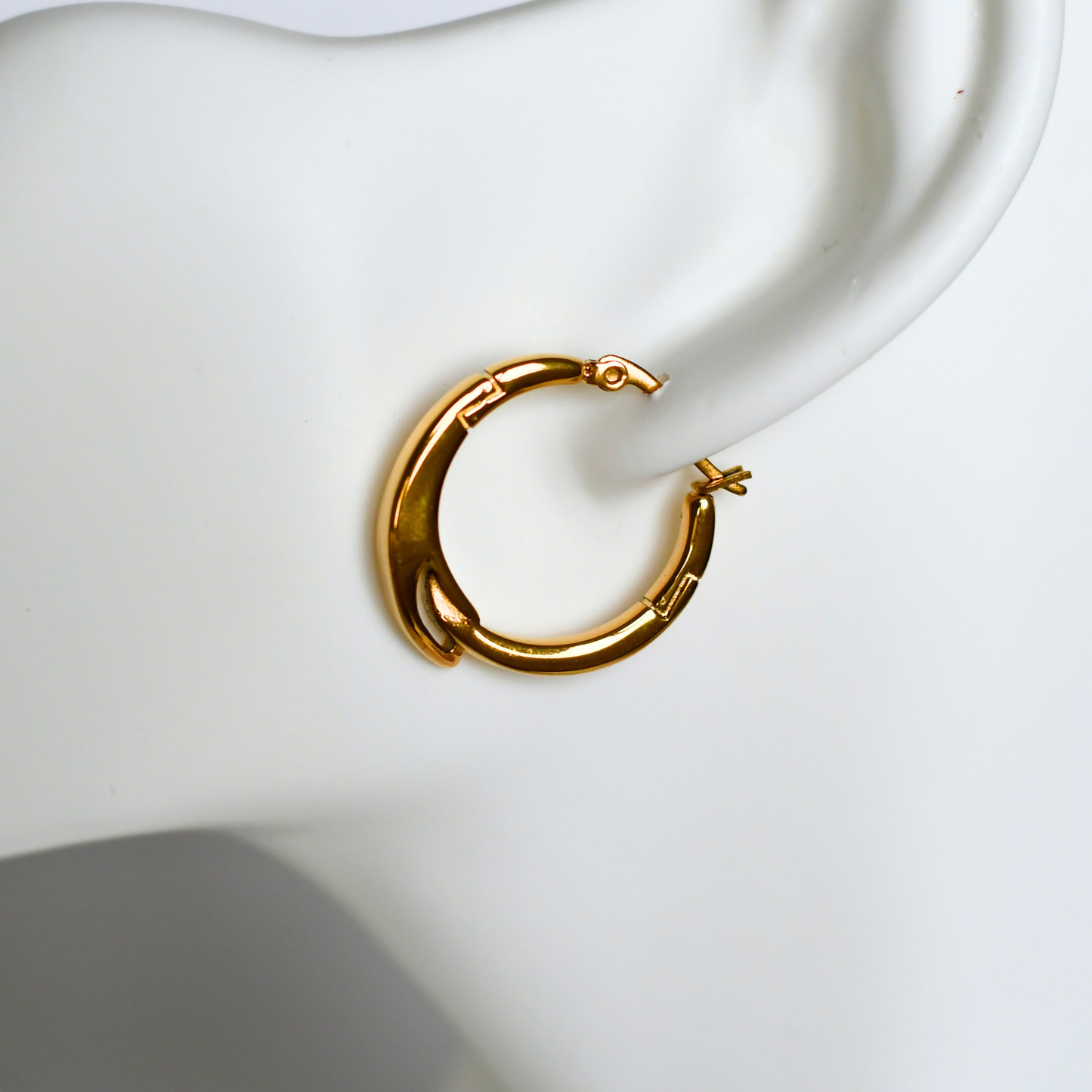 TRESSE stainless steel unique earrings in gold on ear - Alogan